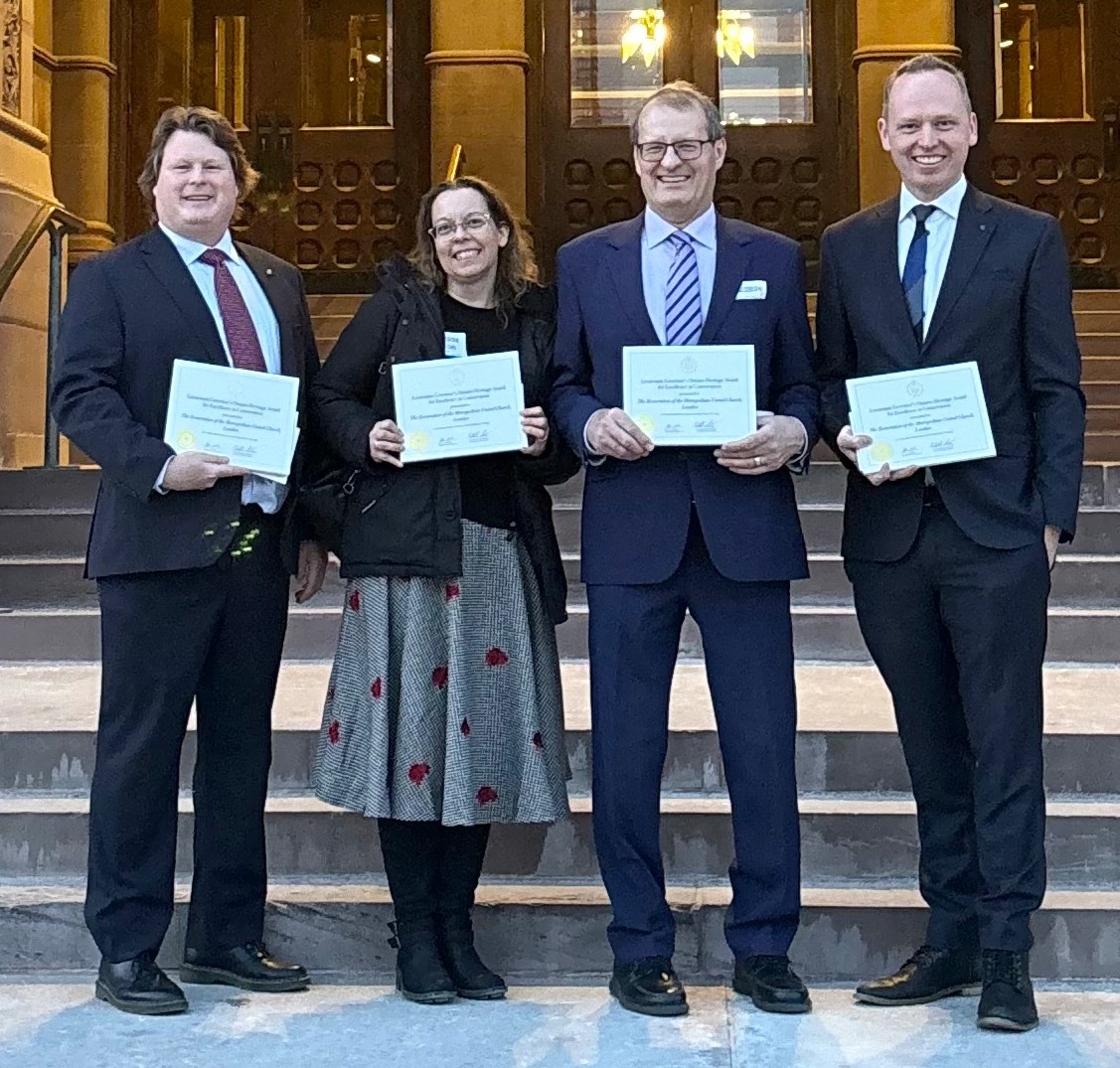 Jeff, Kendra Al, and McMichael hold their award certificates.